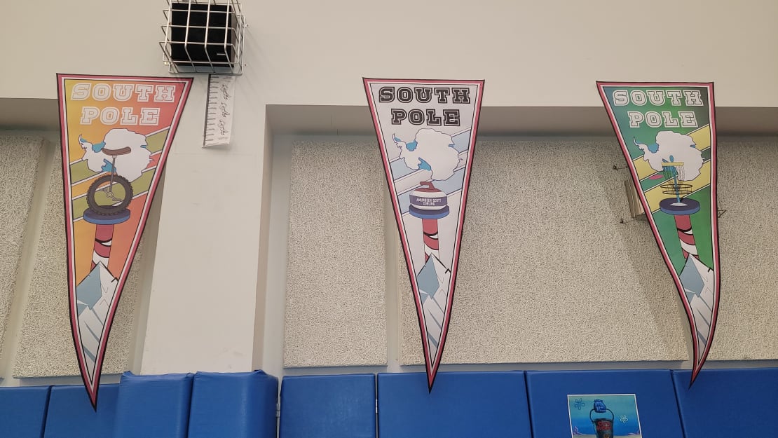 Three sports-themed pennants hung from ceiling.