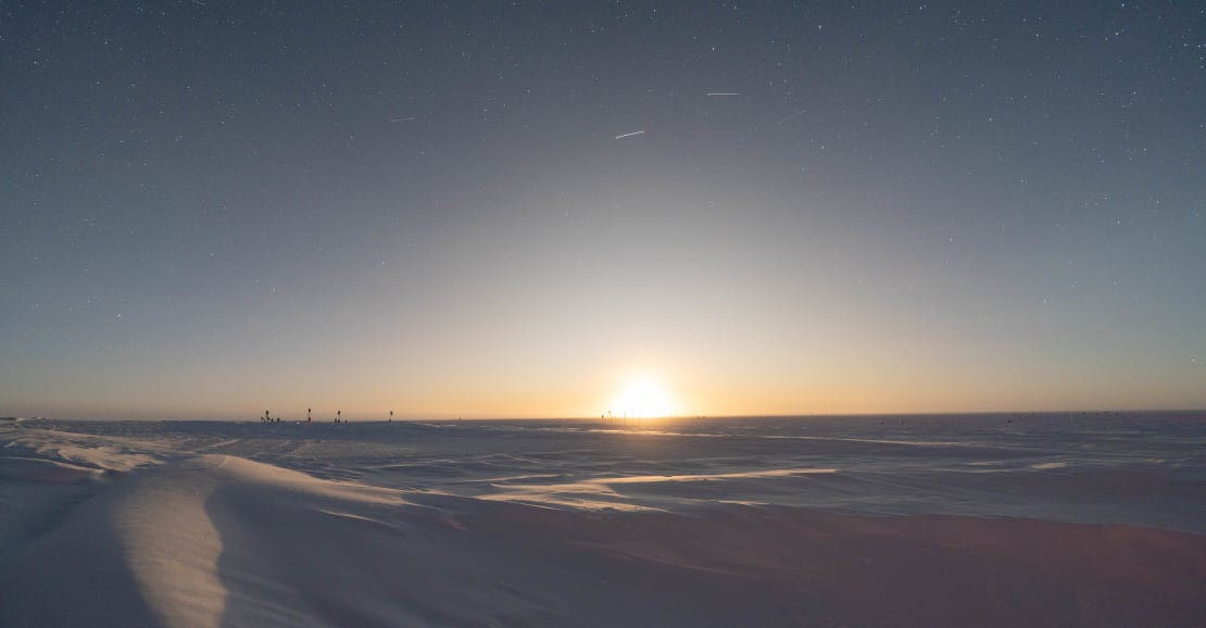 Bright moon on the horizon at the South Pole, looking almost like the sun.