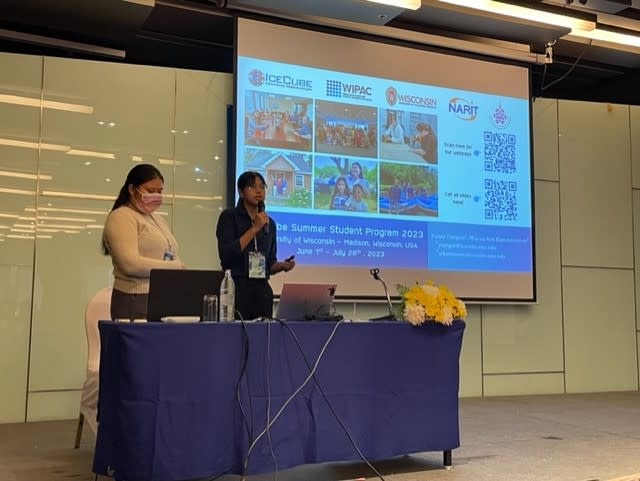 Two women giving a talk in front of a room