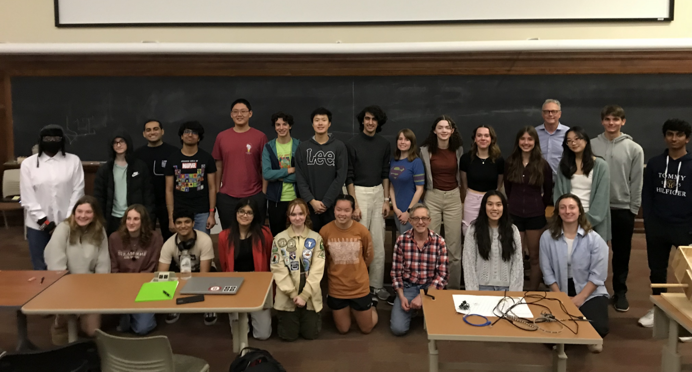 A group of people posing in front of a blackboard