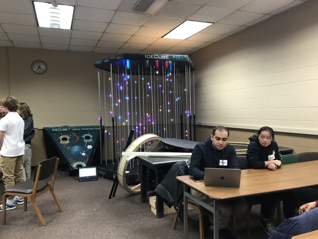 An LED model of the IceCube lab in the background of a classroom