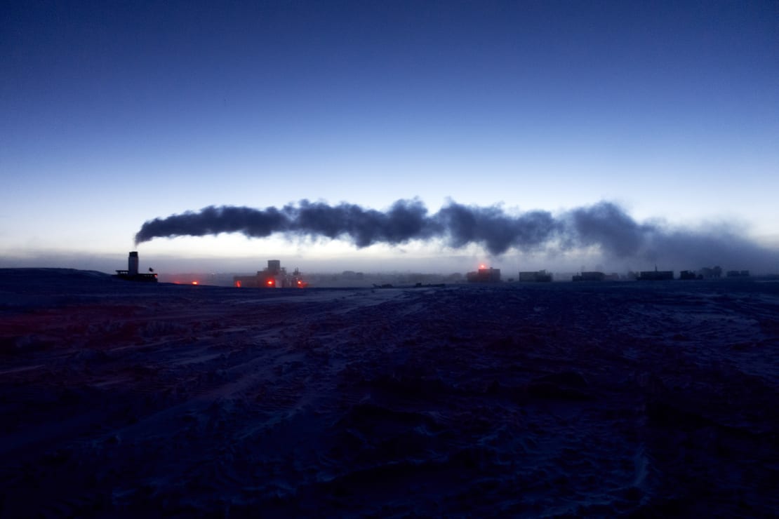 Steam from the South Pole station wafting horizontally across a clear sky after sunset, with lingering light along horizon.