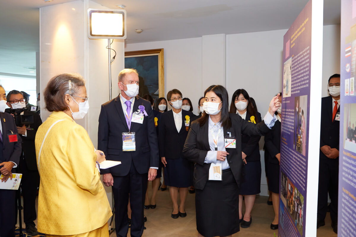 A group of people standing in front of a poster