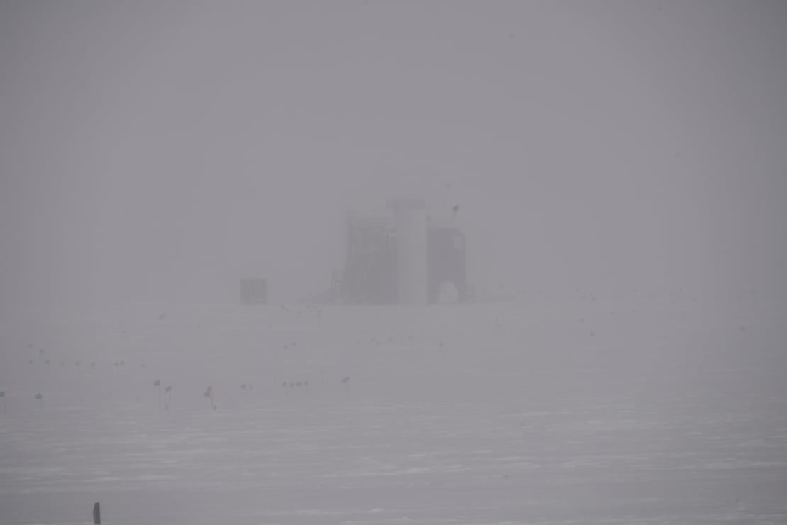 A barely discernible view of the IceCube Lab during bad weather and poor visibility.